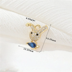 Vue macro du pendentif lapin en or 14k avec zircons blancs et pierre bleue poire