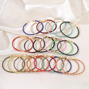 Geflochtenes Seilarmband-Set mit goldenen Metallkappen und bunten Seidenmustern