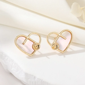 Macro detail of 14K gold heart earrings with iridescent white mother of pearl inlay