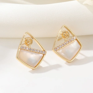 Detailed close-up of 14K gold zircon earrings with white shell inlay and geometric frame