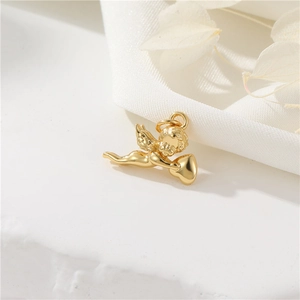 Exquisite 14K gold plated angel pendant with heart design on a white silk background