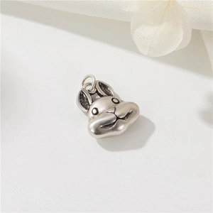Macro view of vintage silver rabbit head charm with 14K gold filled details and hook