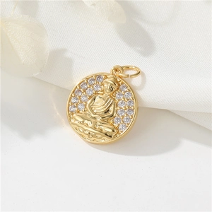14K gold plated Buddha pendant with white zircon stones on white silk background