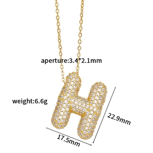 Detail view of 3D gold letter H pendant with pavé set zircons showing dimensions and size