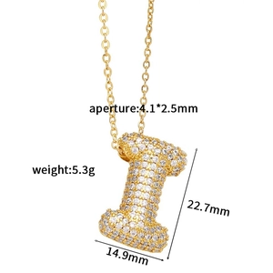 Macro shot of gold letter I pendant with white zircon pavé and detailed measurements