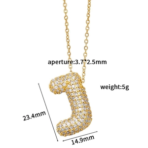 Macro view of gold letter J pendant with white zircon pavé and precise dimensions