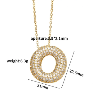 Detailed view of gold donut pendant with cubic zirconia inlay and precise size dimensions