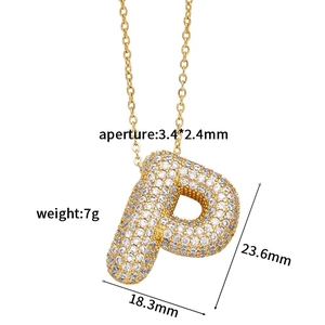 Detailed macro view of gold paved cubic zirconia letter P pendant with size measurements
