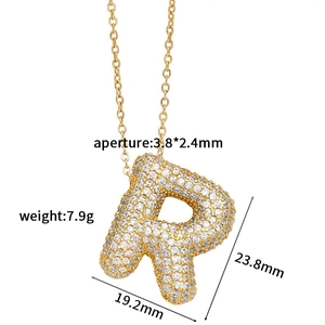 Macro detail of cubic zirconia letter R pendant showing 23.8mm x 19.2mm dimensions