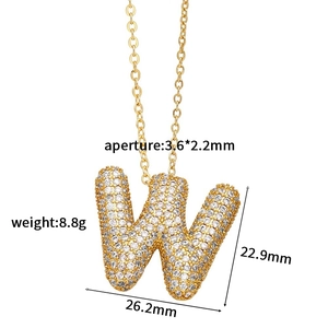 Macro detail of gold-tone pavé cubic zirconia letter W pendant with precise dimensions