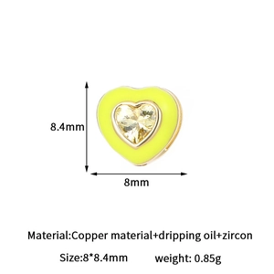 Detail of 14k gold-filled heart charm with yellow enamel and zircon for jewelry making