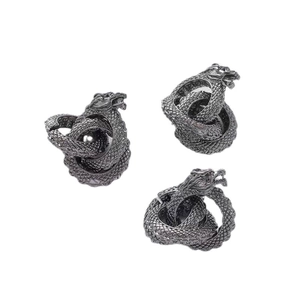 Three vintage grey metal dragon rings with detailed scales in a diagonal layout