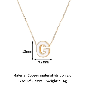 Detail view of 14K gold plated letter G pendant with white enamel inlay and dimensions