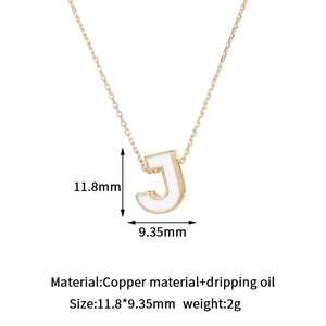 Detailed view of 14K gold-plated letter J pendant with white enamel and size specs