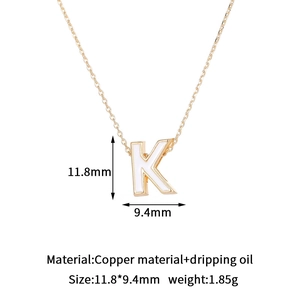 Detail of 14K gold plated letter K pendant with white oil dripping and measurements