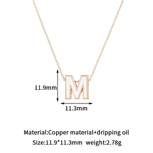 Detailed view of 14K gold-plated letter M pendant with size and weight dimensions
