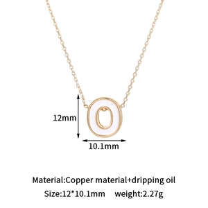 Detail of 14K gold plated letter O pendant with white dripping oil enamel specs