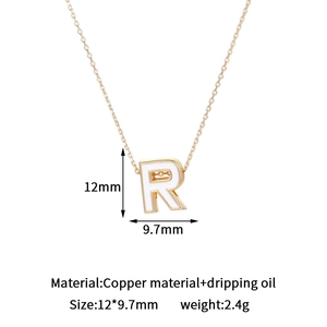 Close-up of 14K gold plated letter R pendant with dimensions 12mm by 9.7mm