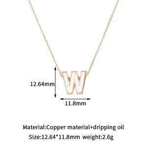 Detail of 14K gold plated letter W charm with white enamel and 12.6mm size markings