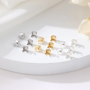 Makroaufnahme von quadratischen Vier-Krallen-Fassungen in Gold und Silber für Schmuck