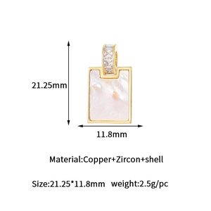 Macro view of rectangular gold-plated copper pendant with white shell and zircon inlay