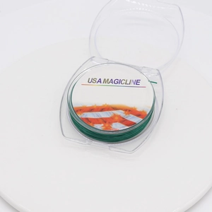 Detail view of USA Magicline green crystal elastic cord for jewelry making on white spool