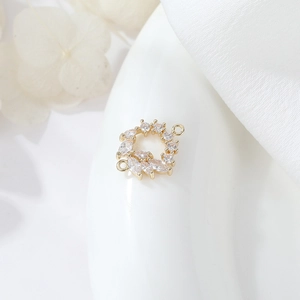 Macro view of gold plated geometric double ring connector with marquise zirconia