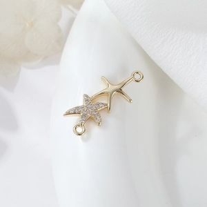 Macro shot of gold-plated starfish connectors with micro-pave cubic zirconia for DIY jewelry