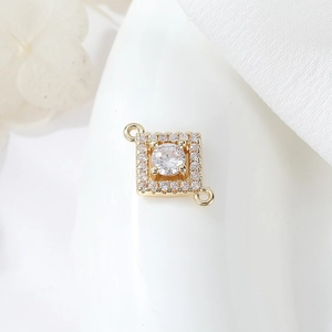 Macro detail of gold plated geometric connector with round zircon for DIY jewelry making