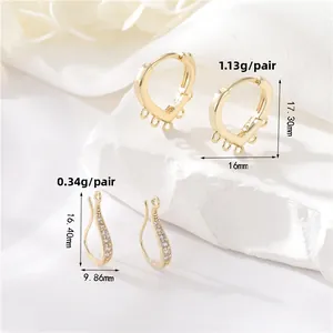 Detailed view of 14K gold plated heart huggie and zircon wave earring findings