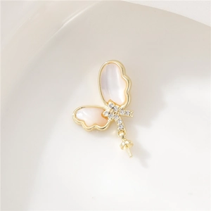 Close-up of 14K gold plated butterfly pendant with white shell inlay and zircon accents