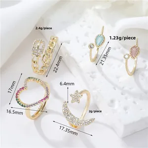 Detail view of 5-piece gold ring set with heart, moon, star and colorful zircon accents