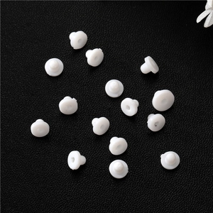 Detailed macro view of 15 pieces of white silicone disk earring backs on black leather