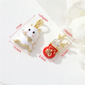 Detail of 14k gold plated ghost and red lucky bag pendants with pearl and zircon accents