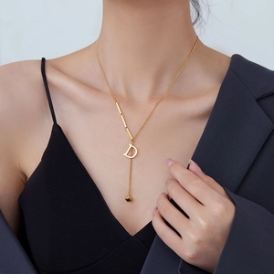 Golden Y-shaped titanium steel necklace with letter D pendant and small gold bead charm