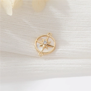Macro detail of 14K gold-plated star pendant with white shell and zircon inlay
