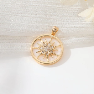 Macro view of 14K gold plated sunburst pendant with white shell and zircon inlay