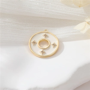 Macro view of 14k gold-filled round white shell pendant with star charms and purple zircon