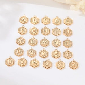 Set of 26 vintage gold hexagonal alphabet charms with textured background and beaded edges