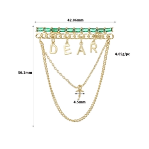 Detail showing gold brooch dimensions with emerald stones, Dear charms and mushroom pendant