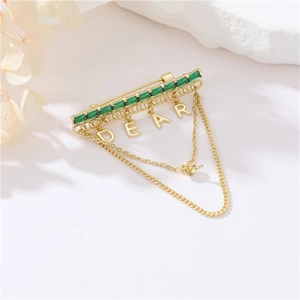 Elegant gold brooch with emerald crystals, DEAR letter pendants and delicate chains