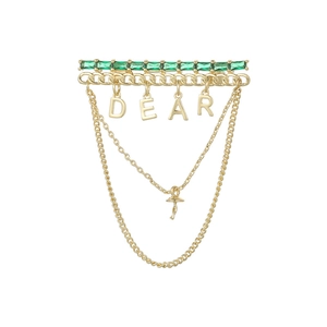 Golden DEAR letter brooch with emerald green stones and dangling chain tassels