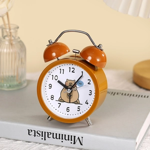 Vintage yellow metal twin bell alarm clock featuring a cute capybara illustration on the dial