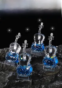 Macro detail of violin-shaped liquid sand ornament with astronaut and blue ocean theme