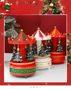 Detailed view of three vintage Christmas carousel music boxes with festive engravings
