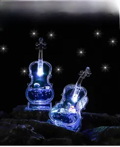 Close-up of violin-shaped night light with cosmic astronaut and glowing blue light