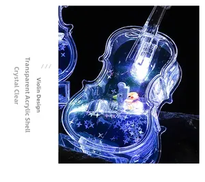 Detail of violin-shaped acrylic LED night light with star sequins and blue glow effect