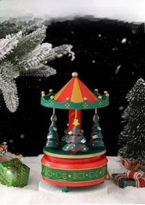 Detail display of Christmas music box with red and green merry-go-round and gold ornaments