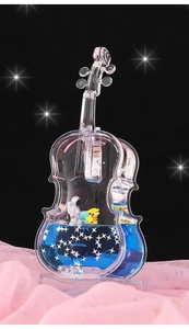 Cello-shaped glowing liquid ornament with floating astronaut and duck in blue ocean theme