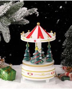 Detail of Christmas carousel music box featuring mini pine trees on a snowy base
